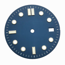 A retro blue and white diving dial with baton hour markers.