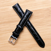 Black leather straps crossed and layered.