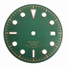 Green and yellow vintage-style diving watch dial with baton and dot markers.