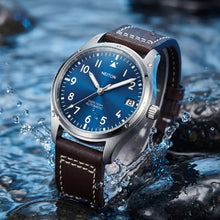 Image of an aviator watch placed sideways in water.