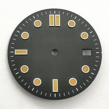 The watch features a retro black and orange diving dial with baton hour markers.